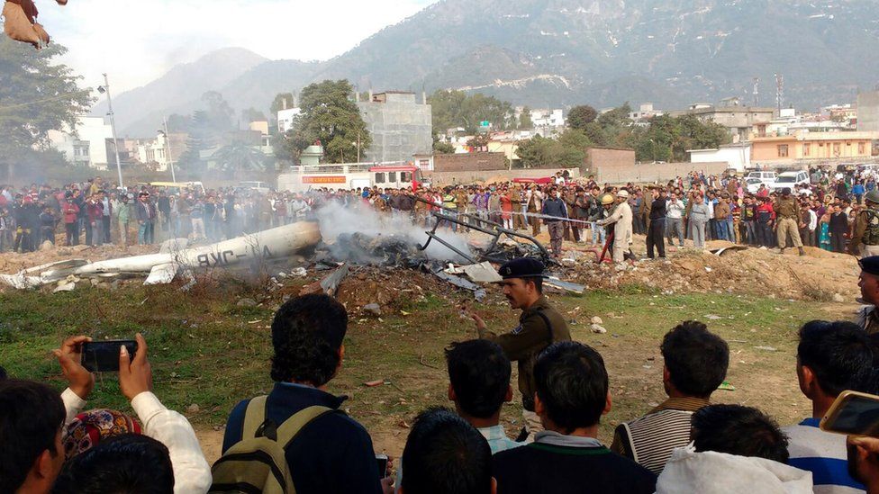Indian people gather at the site of a crash of the Vaishno Devi bounded helicopter at Katra about 45km from Jammu, the winter capital of Kashmir, India, 23 November 2015