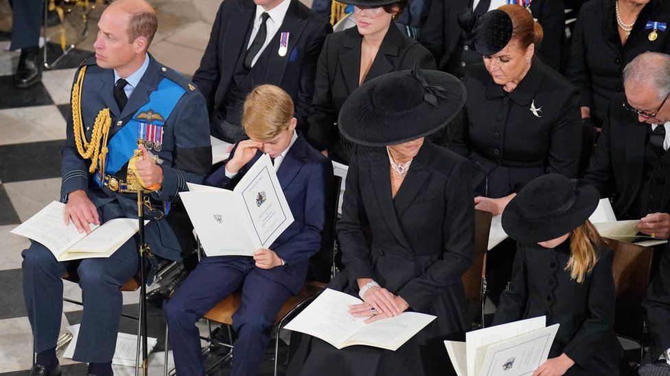 The Prince of Wales, Prince George, the Princess of Wales and Princess Charlotte in front of the coffin of Queen Elizabeth II during her State Funeral at the Abbey in London.