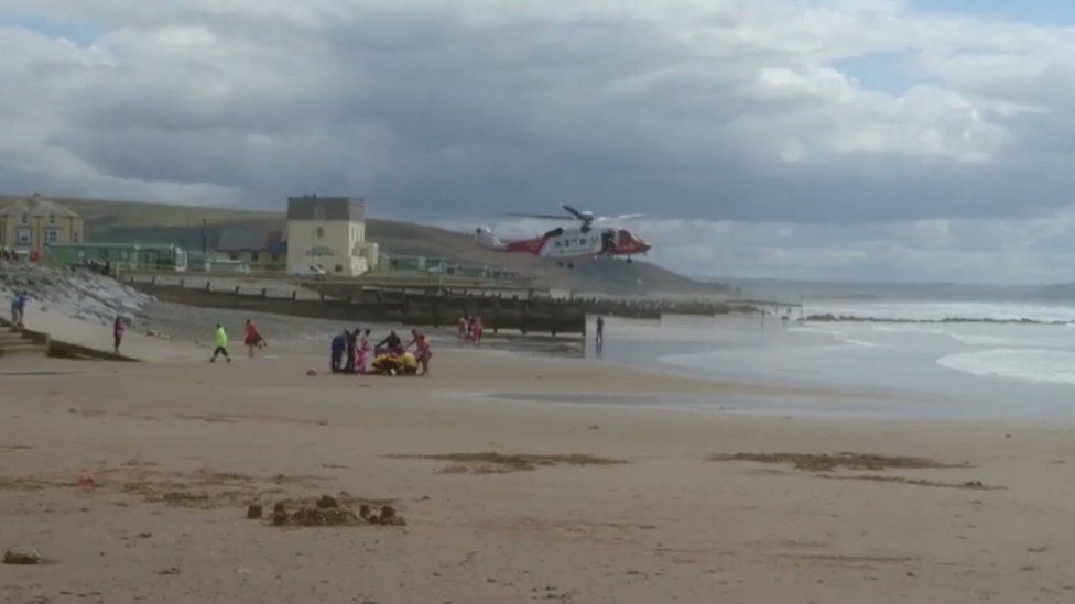 A rescue helicopter about to land on Tywyn beach