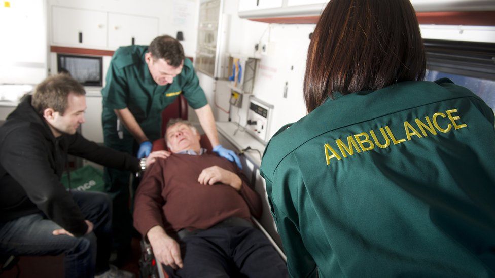 Paramedic and patient on a trolley arriving at hospital