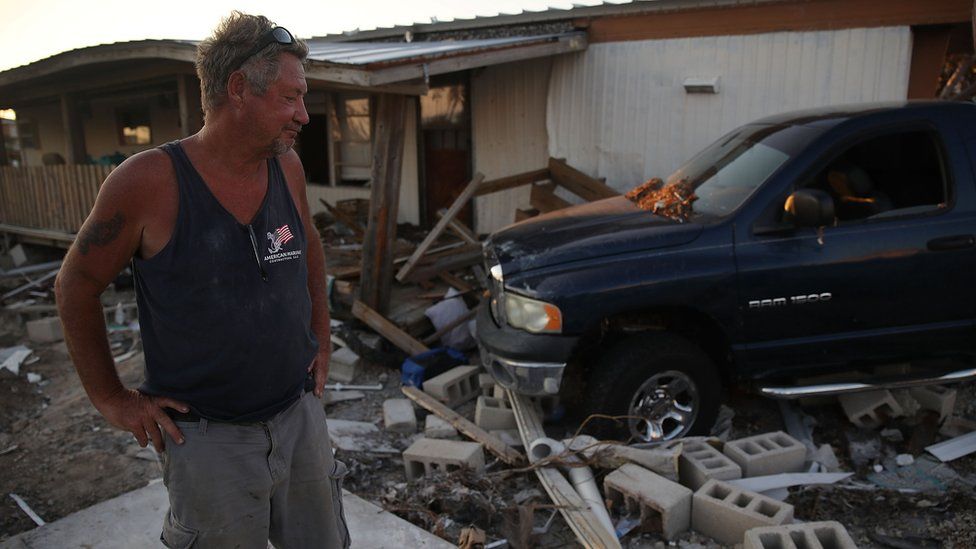 A man checks the damage to his home in Florida after Hurricane Irma last year