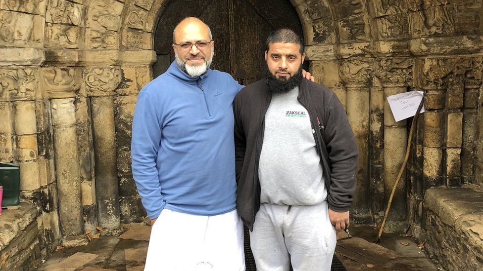 Two members of the Bradford Muslim community deliver supplies