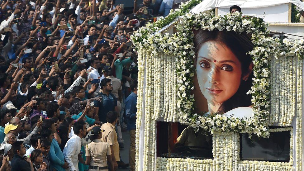 Indian fans watch as the funeral cortege of the late Bollywood actress Sridevi Kapoor passes through Mumbai, 28 February 2018