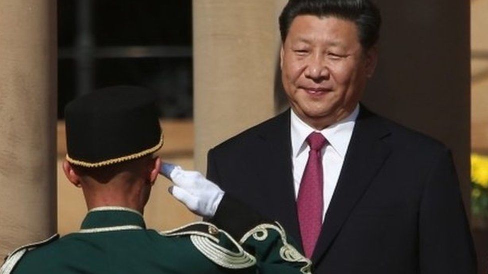 Chinese President Xi Jinping (L) stands in front of the Guard of Honour, flanked by South African President Jacob Zuma (R) at the Union Buildings in Pretoria, during the start of his official tour to South Africa on 2 December 2015