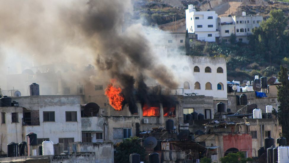 Smoke and fire rises from a Palestinian house in the Jenin refugee camp after it was targeted by the Israeli army on 13 December