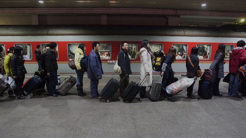 Passengers line up to board a train at the Shanghai Railway Station on January 21, 2009 in Shanghai, China