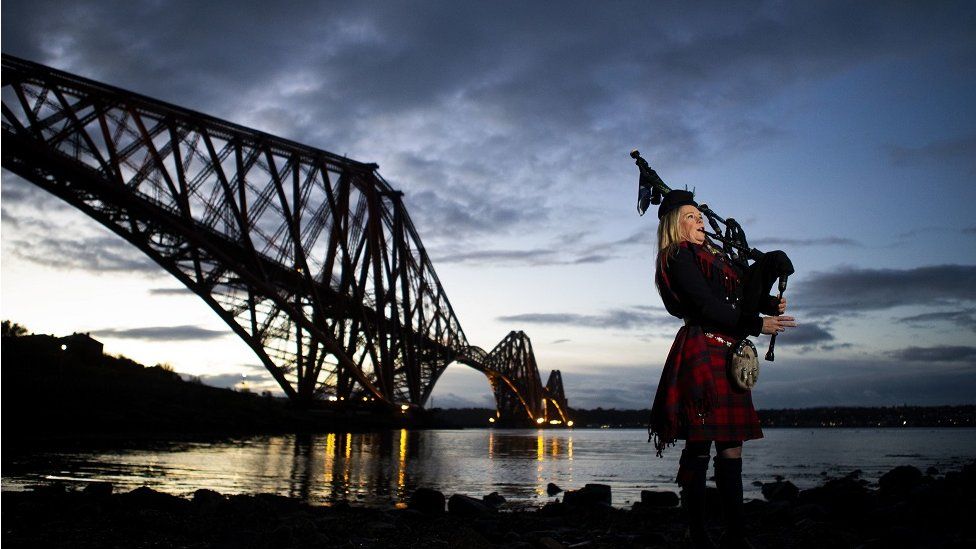 Piper Louise Marshall, wearing a special commemorative red tartan, plays Battle"s O"er, the traditional Scottish lament played at the end of battle, at dawn alongside the Forth Bridge at North Queensferry on the 100th anniversary of the signing of the Armistice which marked the end of the First World War