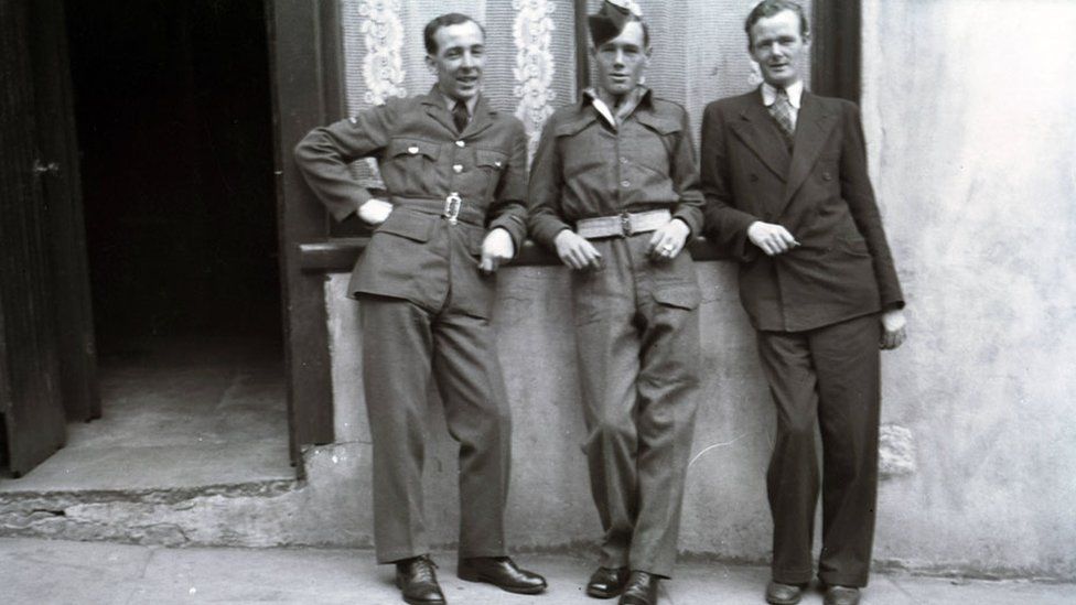 Thomas McBrien on the left in the group of three pictured outside his home in Enniskillen after the war in 1946