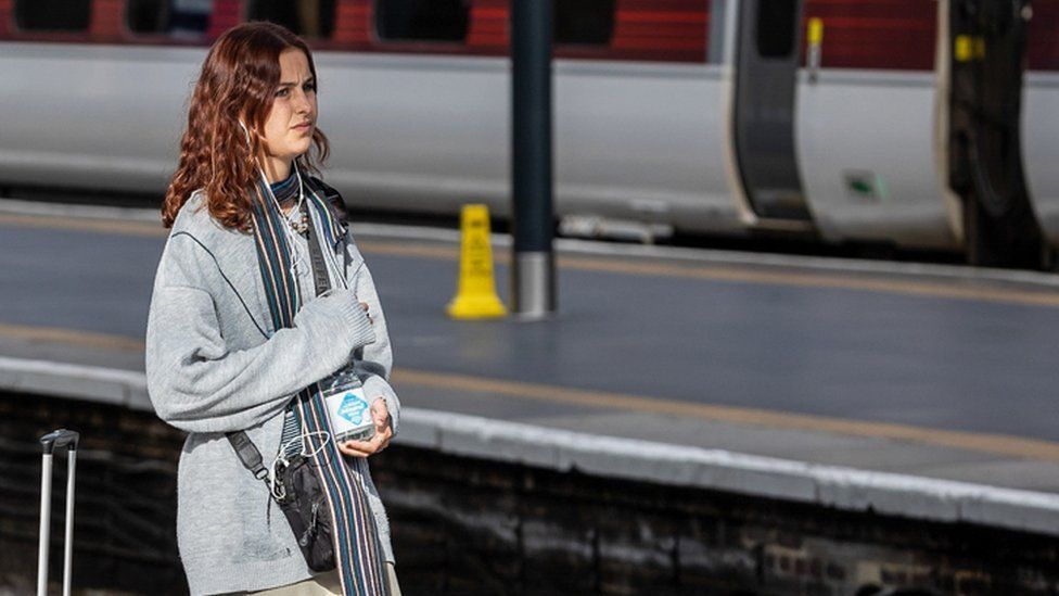 Woman at London rail station during October strike 2022