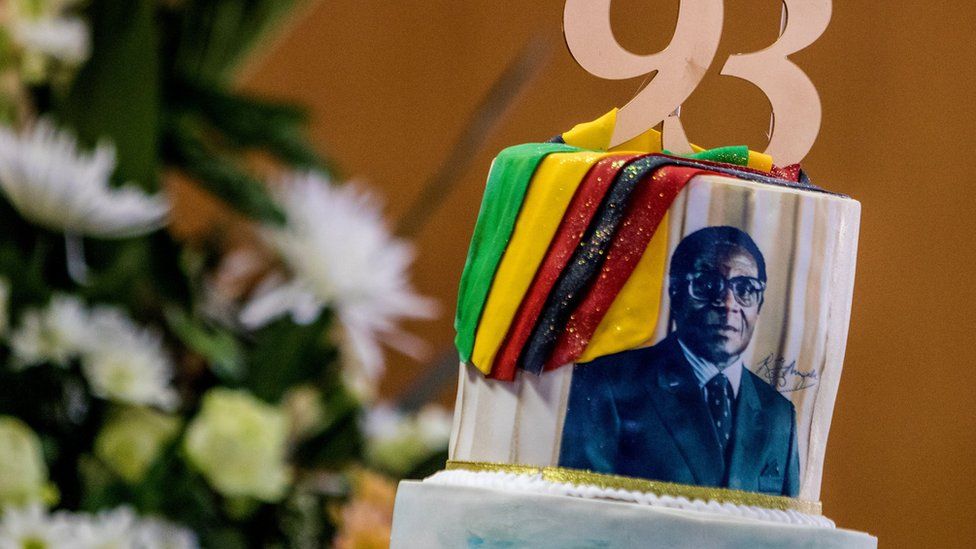 A picture taken on February 21, 2017 shows a cake bearing a portrait of Zimbabwe's President Robert Mugabe during a private ceremony to celebrate Mugabe's 93rd birthday in Harare. Mugabe, the world's oldest national ruler, turned 93, using a long and occasionally rambling interview to vow to remain in power despite growing signs of frailty.