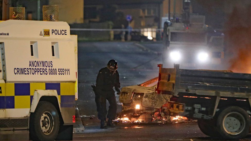 A police officer in riot gear at the scene of the violence in Londonderry