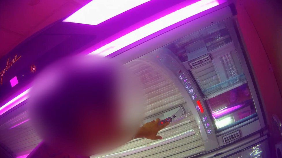 blurred out figure standing beside a sunbed