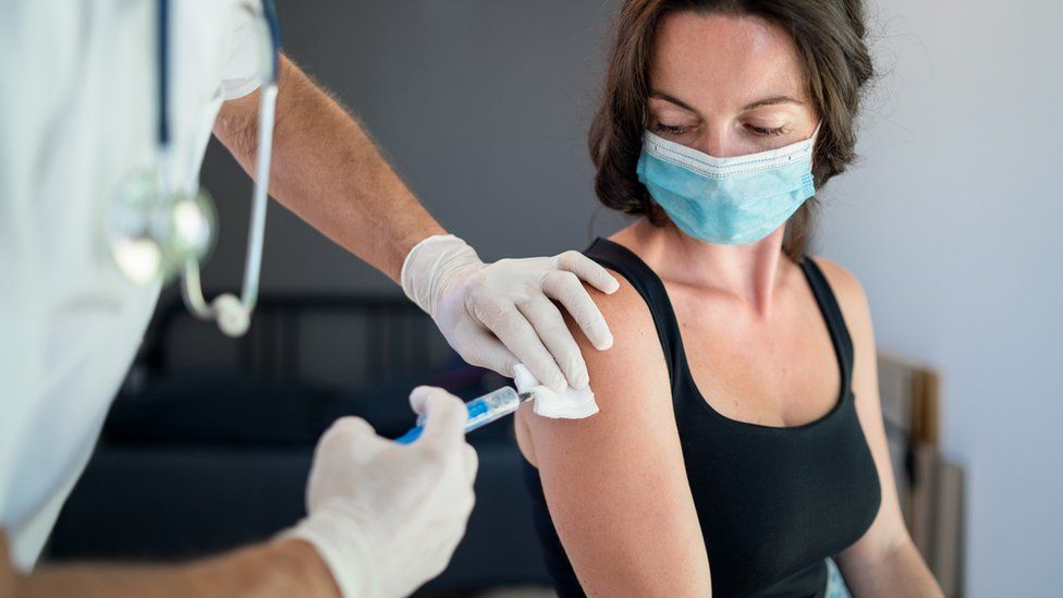 woman getting her vaccine