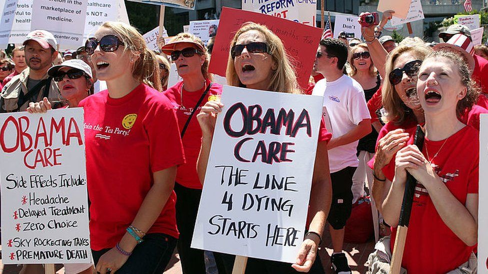 Anti-Obamacare protesters hold up signs at a 2009 rally.