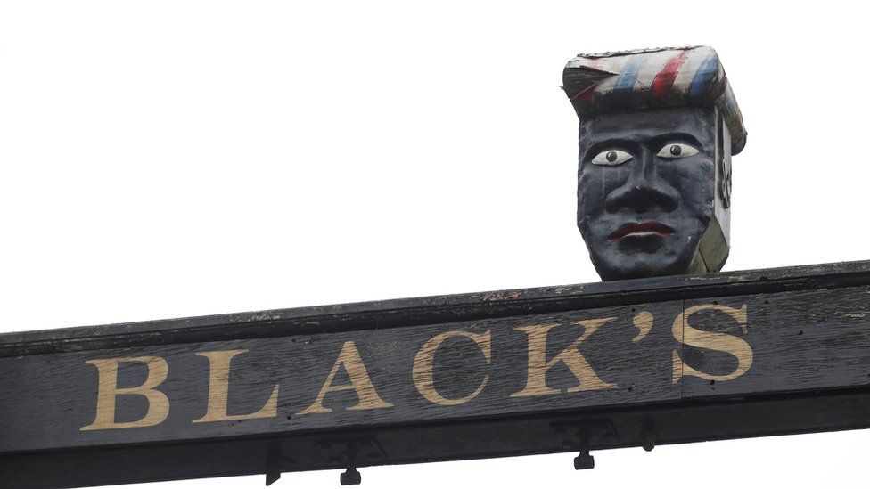 Sign above The Green Man and Black's Head Hotel