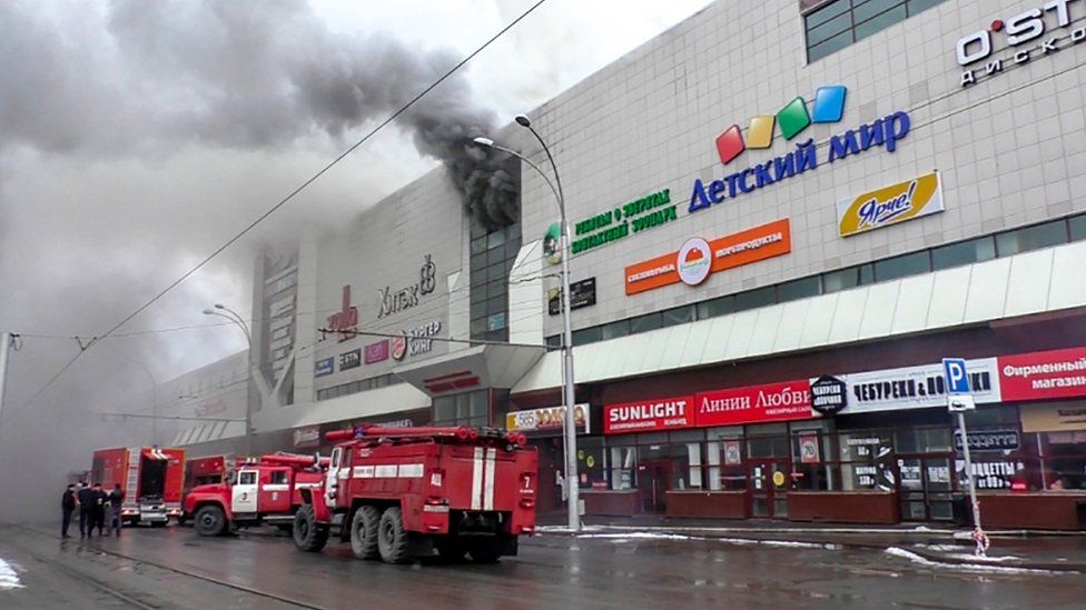 Emergency vehicles outside a burning shopping centre in Kemerovo, Russia. 25 March 2018