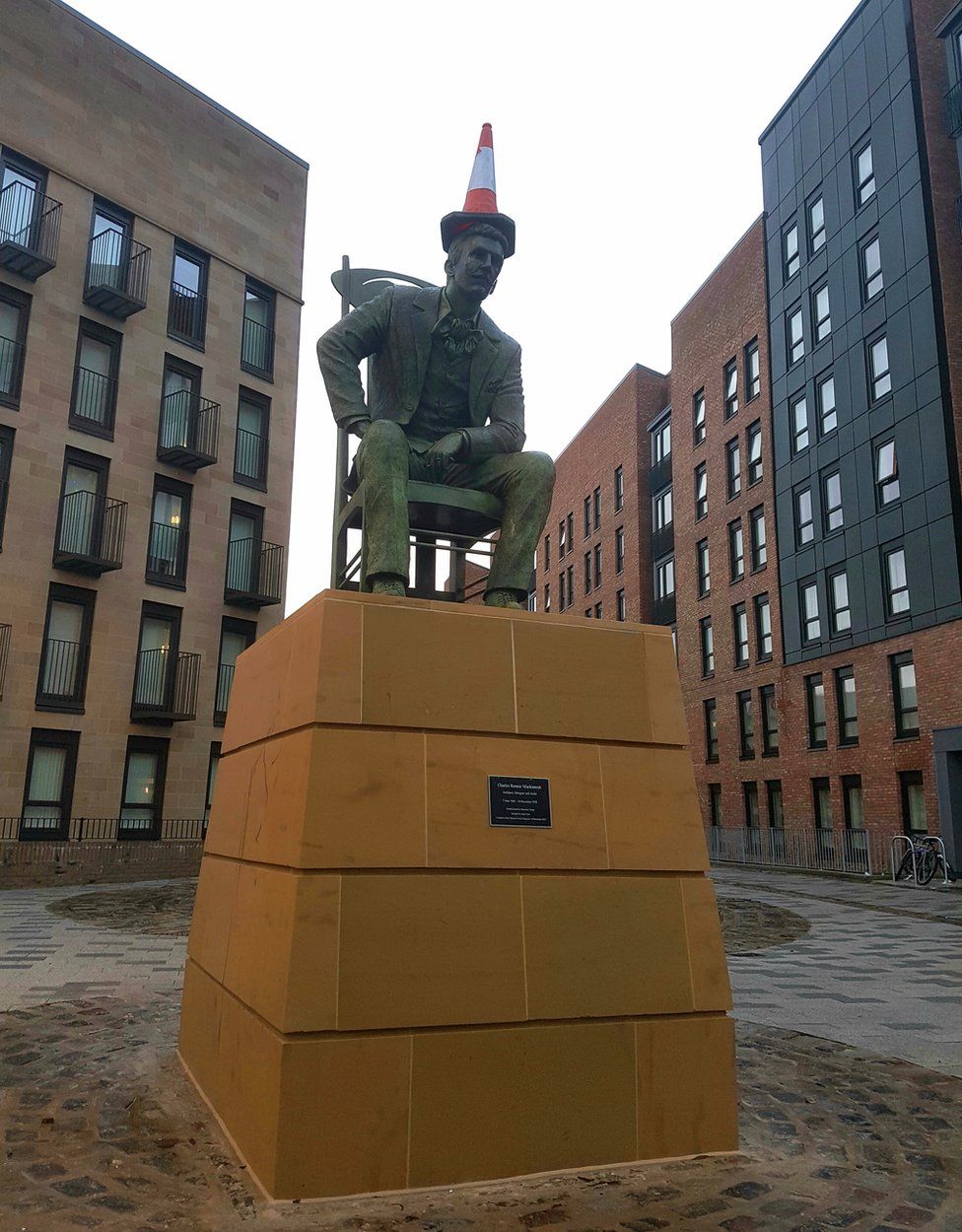 Mackintosh statue with cone on its head