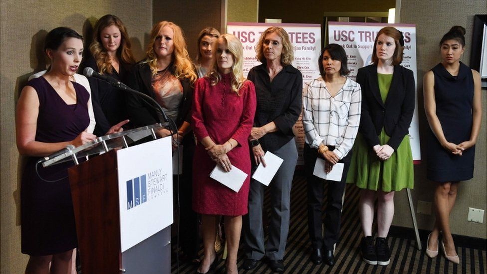 Group of women speaking at podium