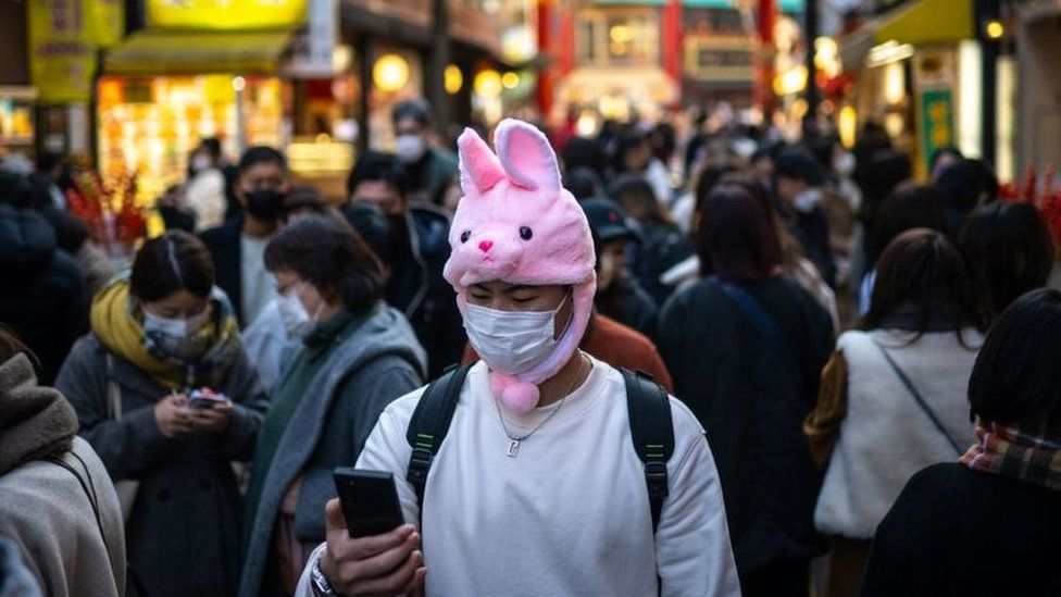 People walk down a street in the Chinatown section of Yokohama.