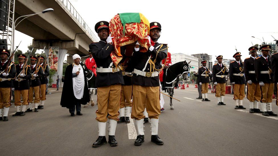 Pallbearers carry a flag-draped casket of Simegnew Bekele Ethiopia's Grand Renaissance Dam Project Manager who was found dead in his vehicle on Thursday