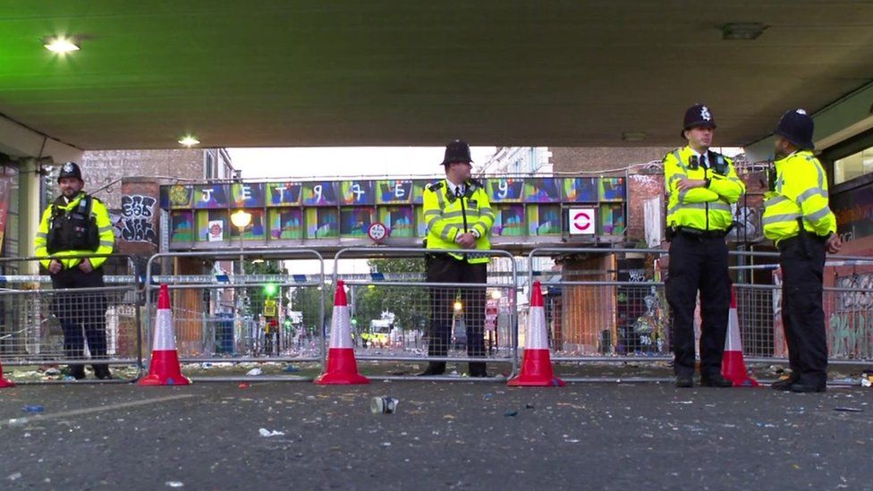 Police officers stand near the cordon