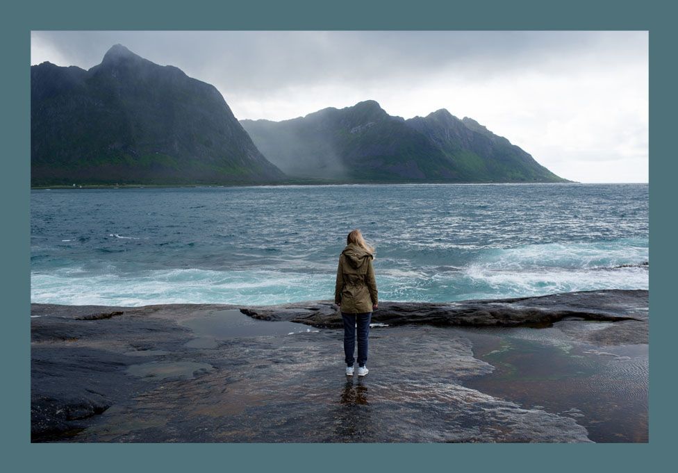 Stock photo of a woman looking out to sea