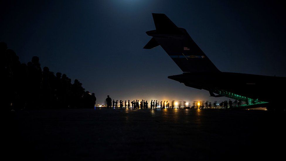 Evacuees board a US Air Force C-17 Globemaster III aircraft