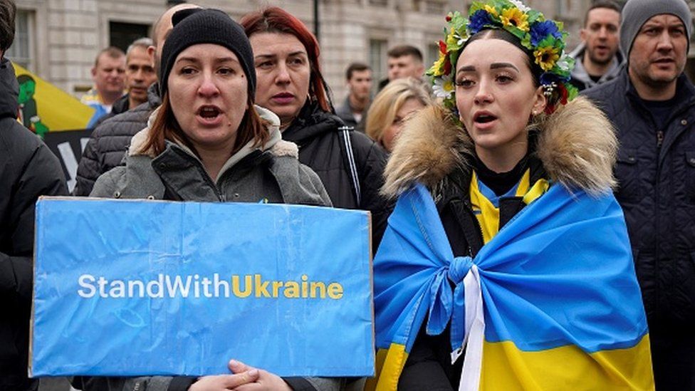 People hold placards during a rally in support of Ukraine