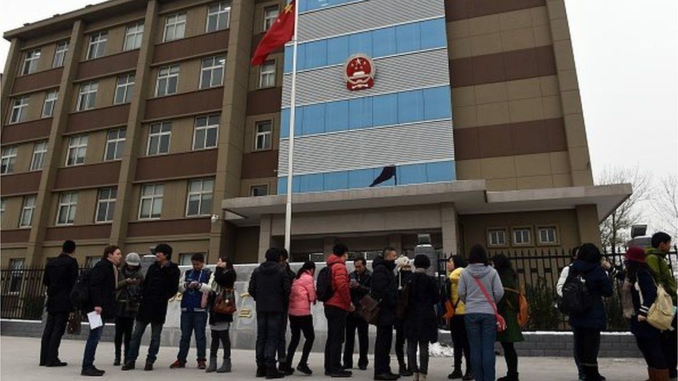 Journalists and gay rights activists stand outside the Beijing No.1 Intermediate People's Court in Beijing before lesbian activist Qiu Bai enters on November 24, 2015.