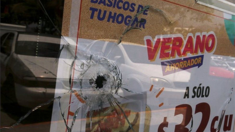 A bullet hole is seen in a window of a convenience store in Acapulco on 18 July, 2018.
