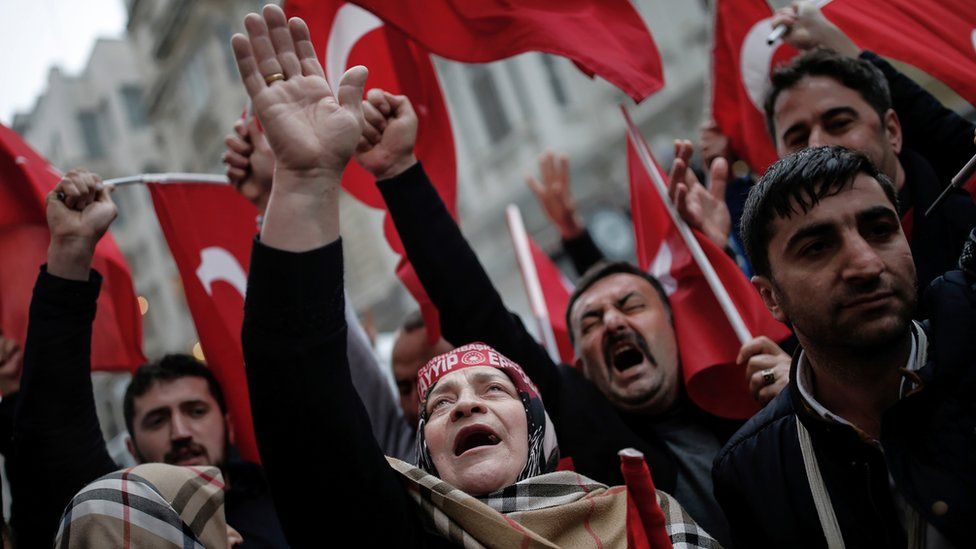 A group of Turks protest outside the Dutch consulate in Istanbul, Sunday, March 12, 2017.