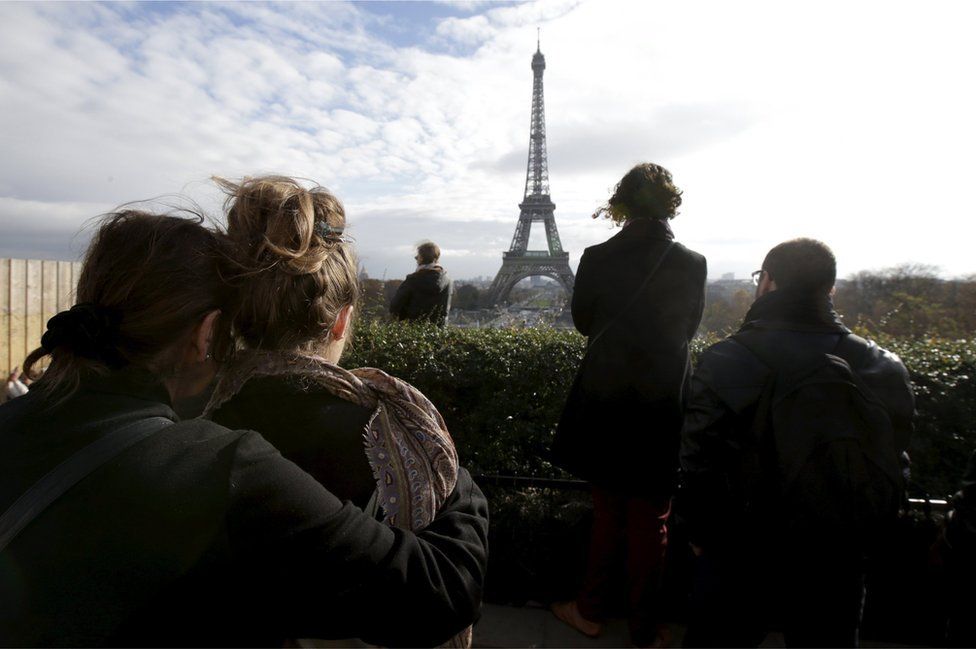 People observe a minute of silence at the Trocadero in front the Eiffel Tower