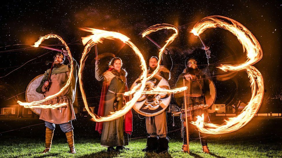 Viking reenactors use flaming torches to write 2023 during the Flamborough Fire Festival, a Viking themed parade in aid of charities and local community groups, held on New Year's Eve in Flamborough near Bridlington, Yorkshire. Picture date: Saturday December 31, 2022.
