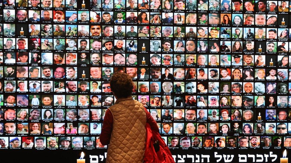 A large screen at the National Library of Israel in Jerusalem projects Israeli victims of the 7 October attack and the soldiers who were killed in the subsequent fighting in Gaza