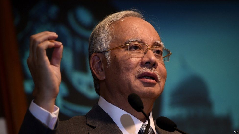 Malaysian Prime Minister Najib Razak gestures while addressing an event for new government interns at the Prime Minister's office in Putrajaya on 8 July 2015