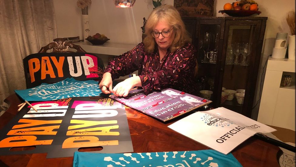 Helen Butler preparing signs to take to a rally