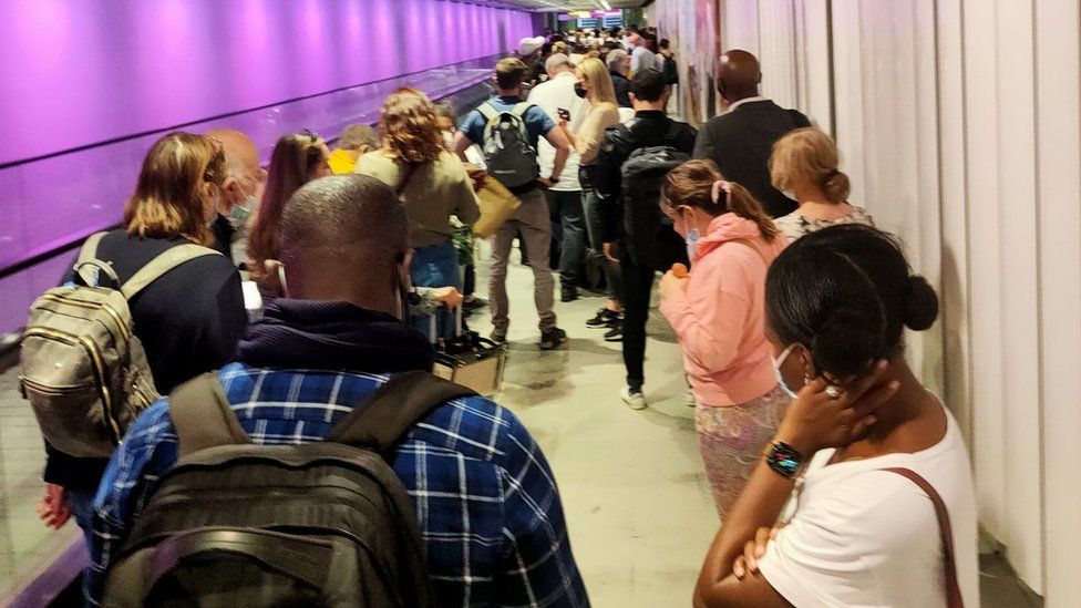 People queuing at Heathrow Airport