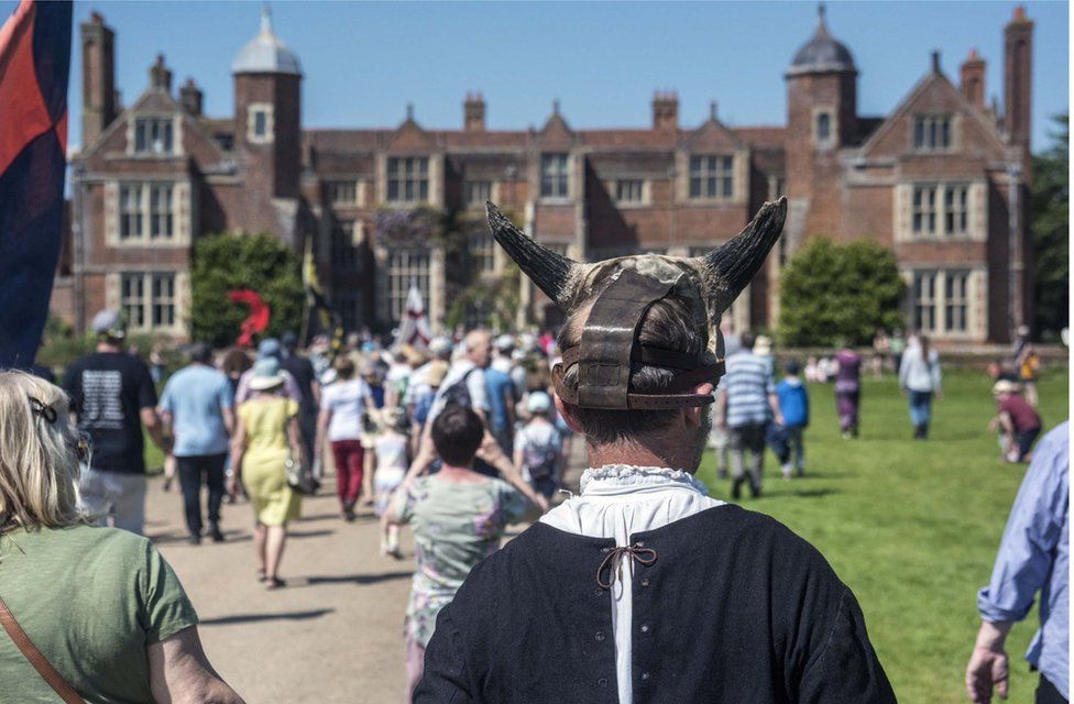 The procession heads to Kentwell Hall for the play