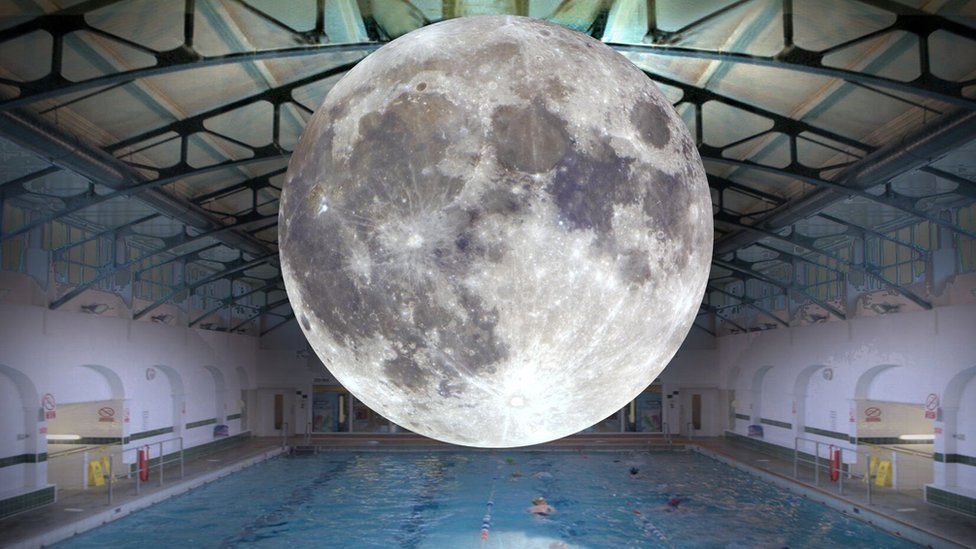 Moon balloon superimposed above a swimming pool