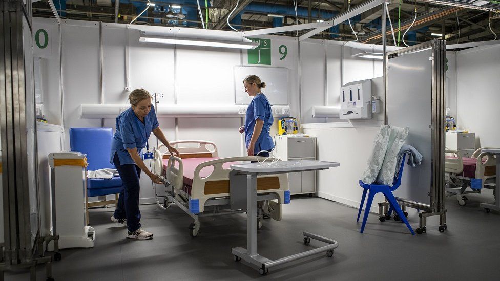 Nurses making a bed in NHS Louisa Jordan hospital