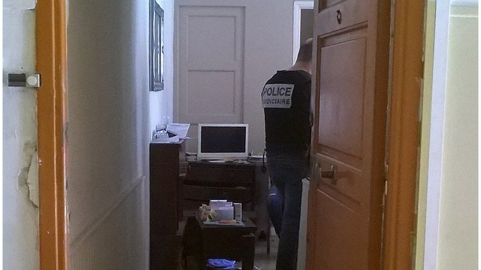 French police officers look for evidences in the flat where the man who drove a truck into a crowd watching a fireworks display the day before reportedly lived, on July 15, 2016 in Nice