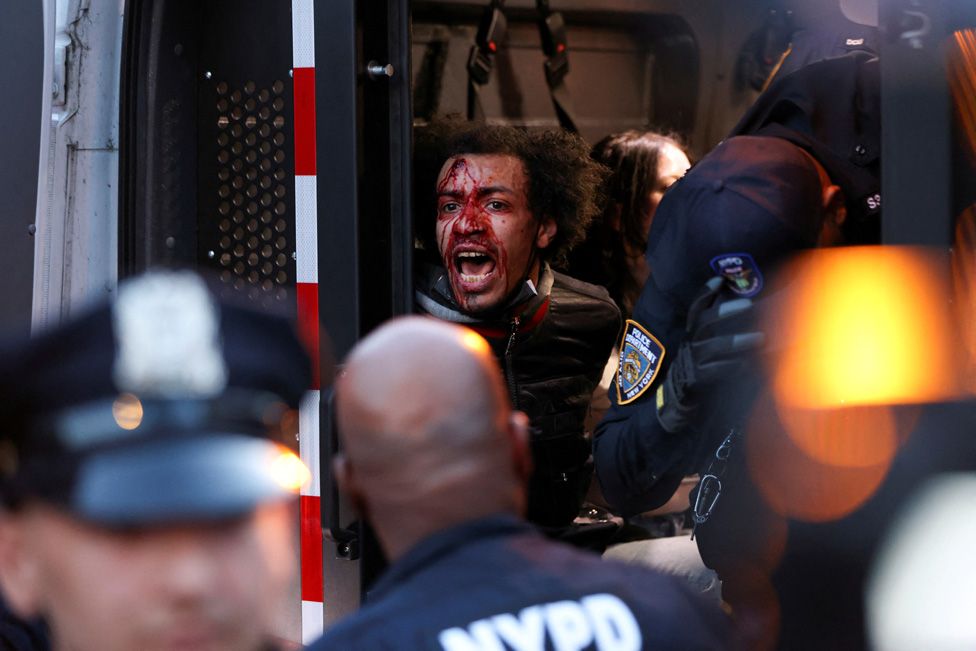 A man is detained by police officers as people protest the death of Jordan Neely in New York City, U.S., May 8, 2023.