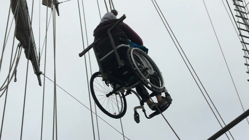 Wheelchair suspended on ropes on the Lord Nelson