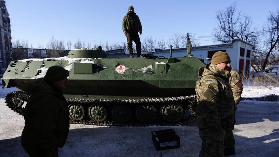 Ukrainian servicemen stand on an Armoured Personnel Carriers in Avdiivka, 30 January 2017.