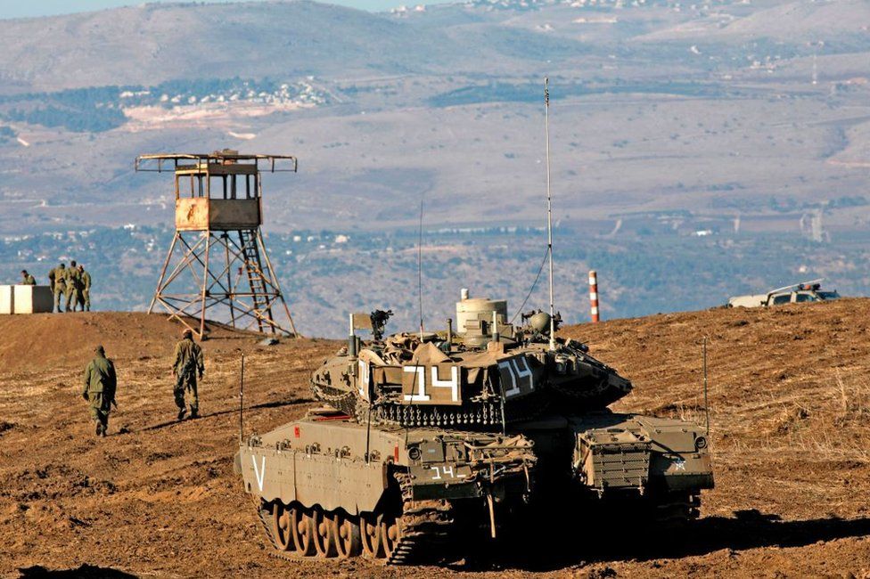 File photo showing Israeli soldiers and armoured vehicles pictured near the frontier with Syria in the occupied Golan Heights (19 November 2019)