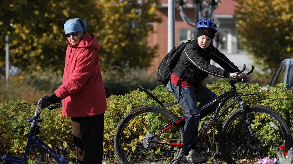 Old woman and young boy in Kauhajoki, southwestern Finland