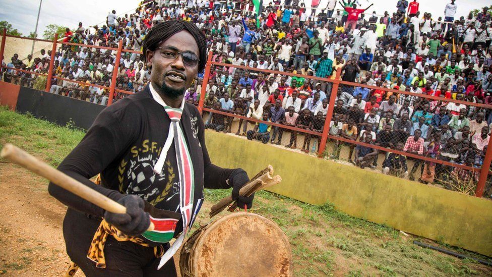 A man entertains the crowd before the first round African Nations Championship qualifying football match between South Sudan and Somalia at Juba Football Stadium on April 30, 2017