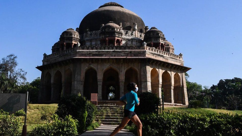 A woman jogs at Lodhi Garden after the local government eased restrictions imposed as a preventive measure against the spread of the COVID-19 coronavirus in New Delhi on May 21, 2020.