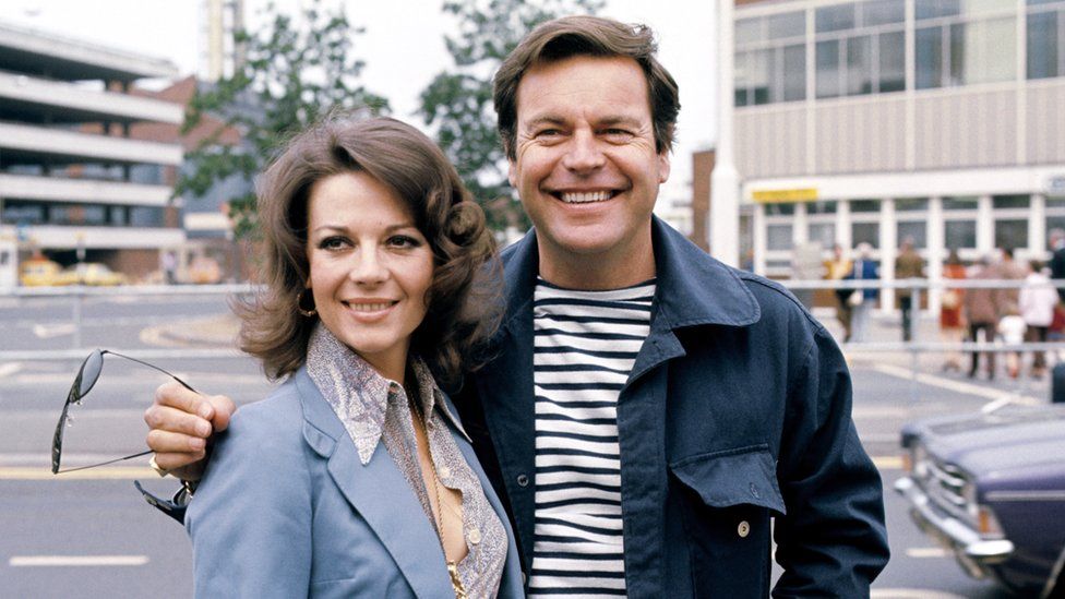 American actor Robert Wagner and his actress wife Natalie Wood at Heathrow Airport in London, 1976.