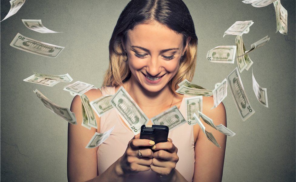 Women on smartphone with dollars coming out of it